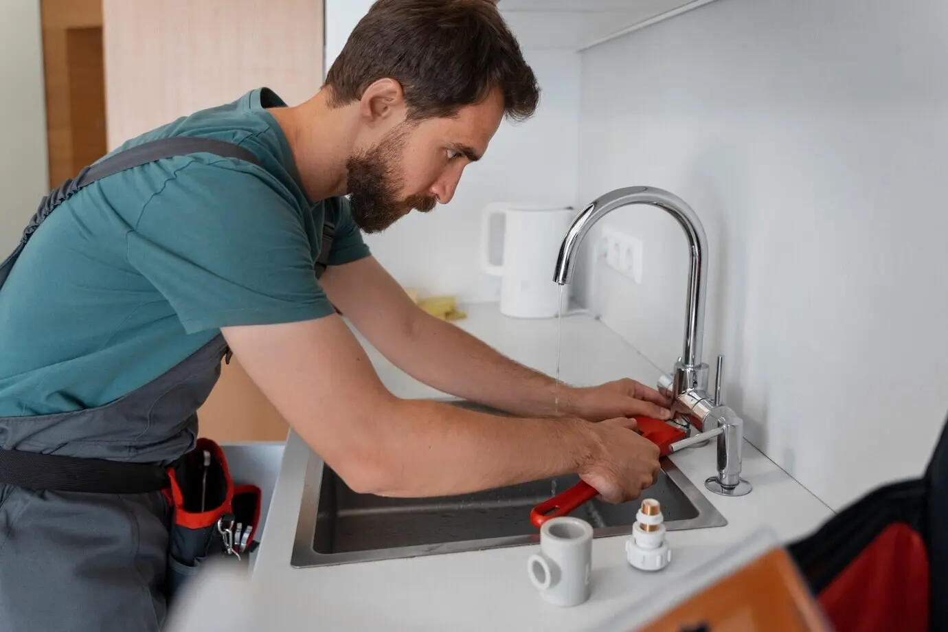 Side view of a man working as a plumber